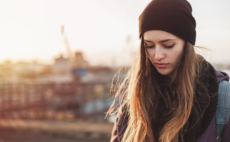 Portrait of a sad girl at sunset