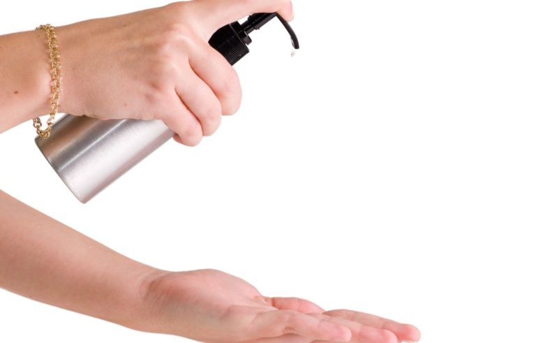 pump bottle of lotion being pumped into hand