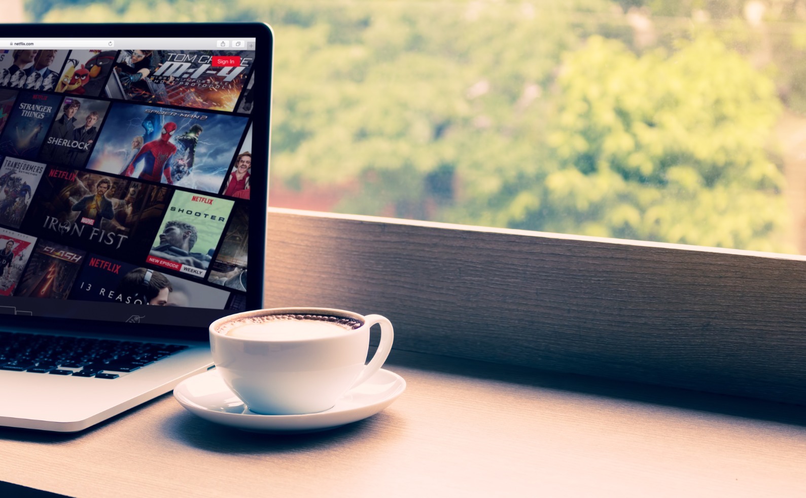 netflix website showing on screen laptop with macbook pro at cafe picture id834399986 (1)