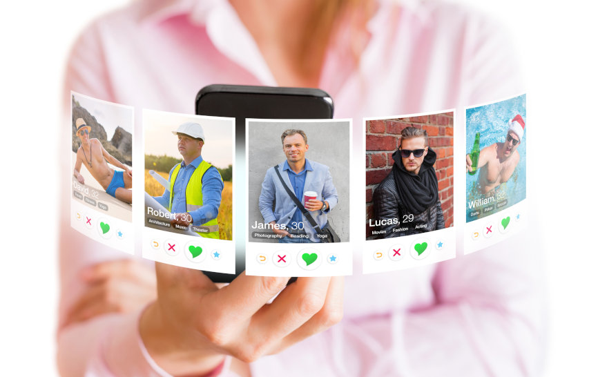 Concept of online dating. Woman viewing different men profile photos in dating app on mobile phone.